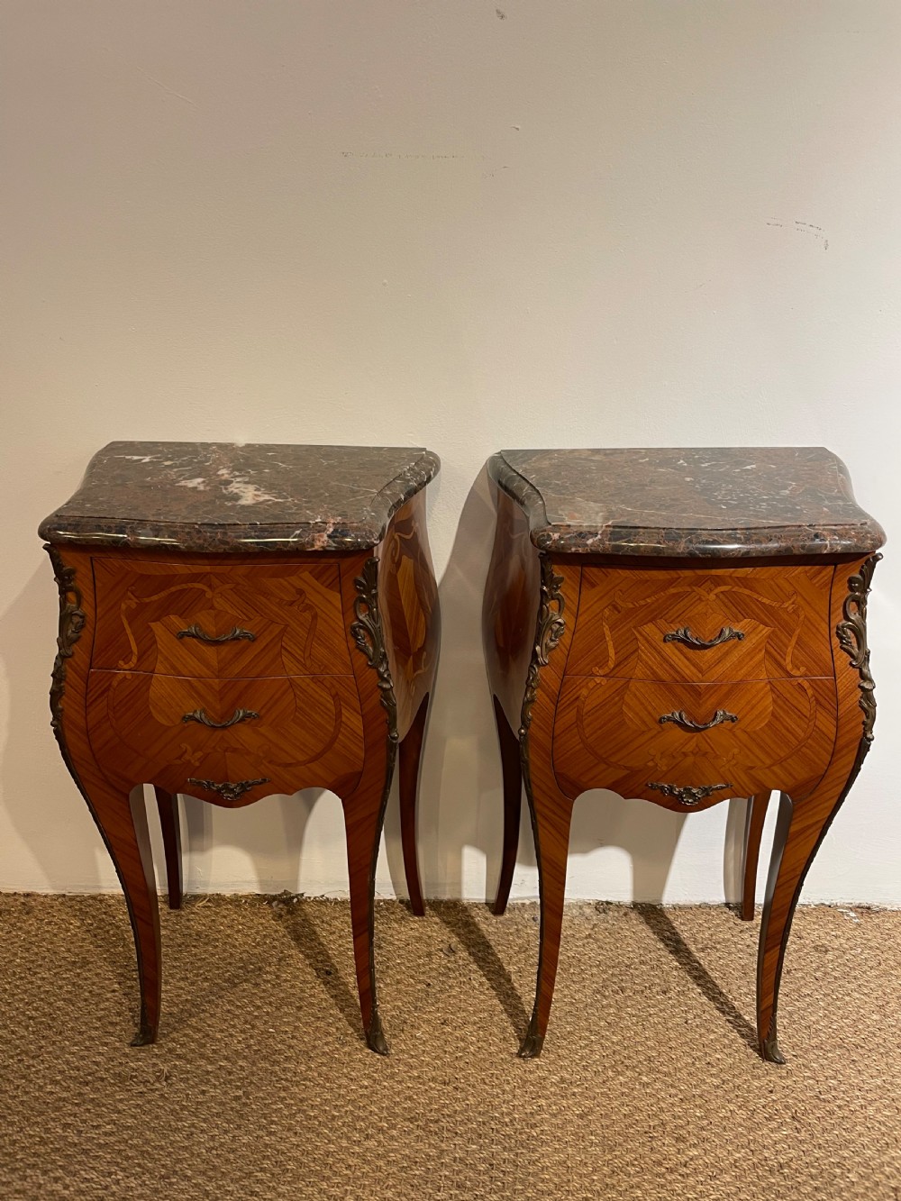 pair of marble topped bedside cabinets